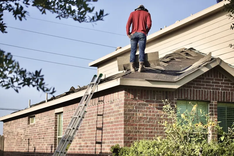 Professional roofer working on a residential roof in Perrineville